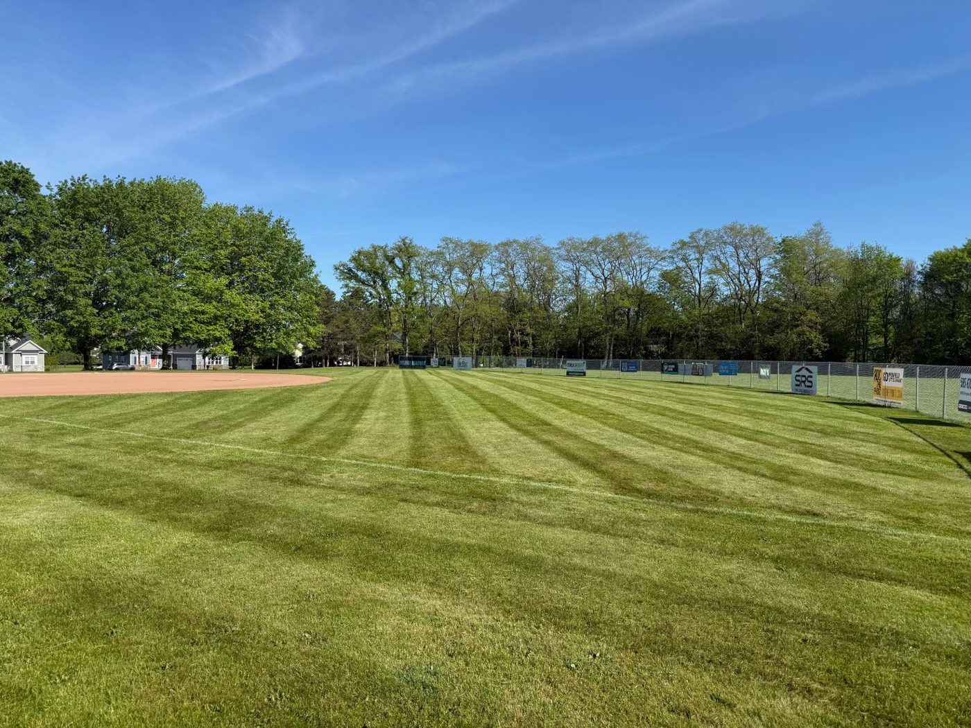 Baseball field mowed with crisp, even stripe patterns